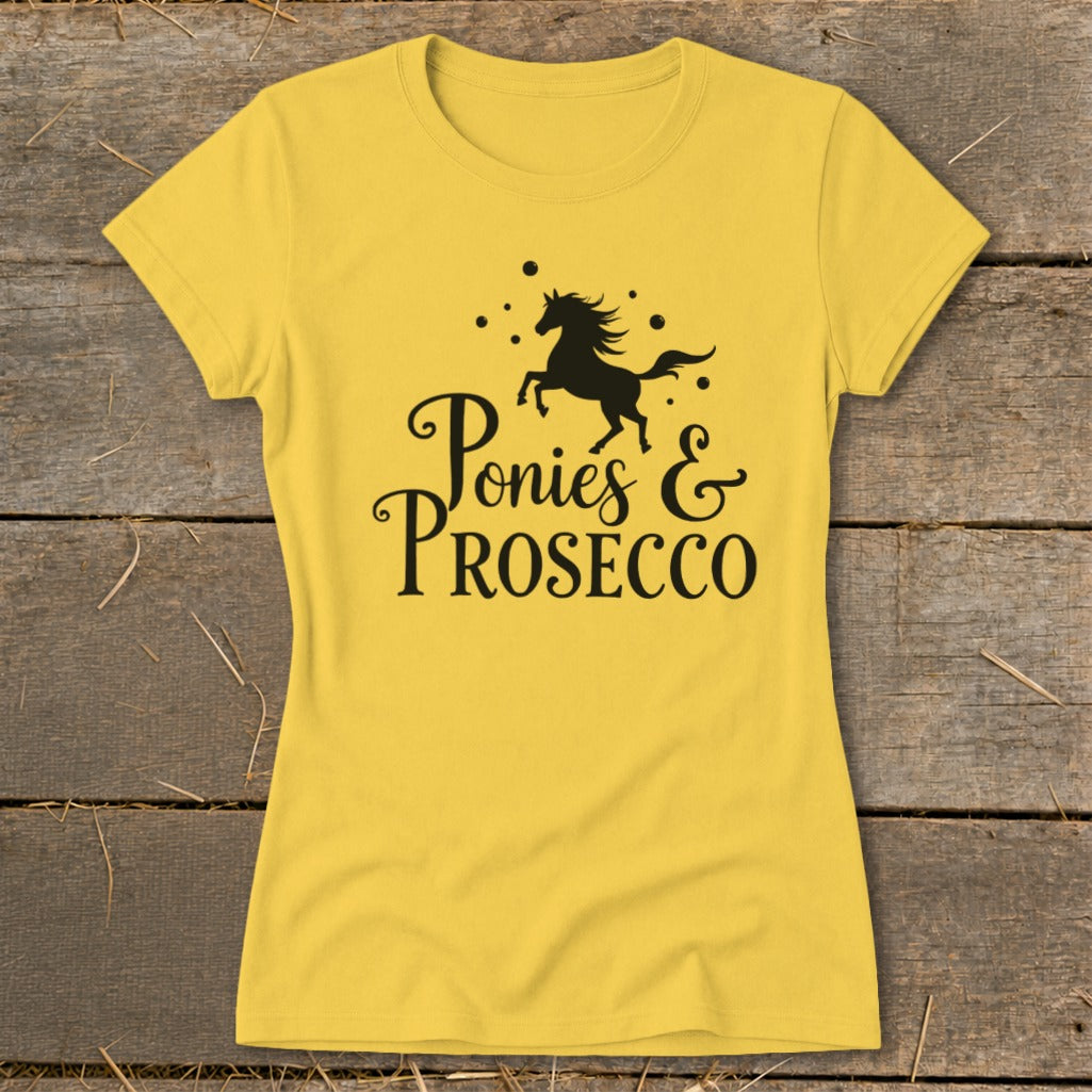 Yellow t-shirt with black text "Ponies & Prosecco" and a galloping horse graphic.