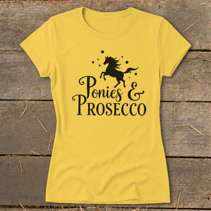 Yellow t-shirt with black text "Ponies & Prosecco" and a galloping horse graphic.