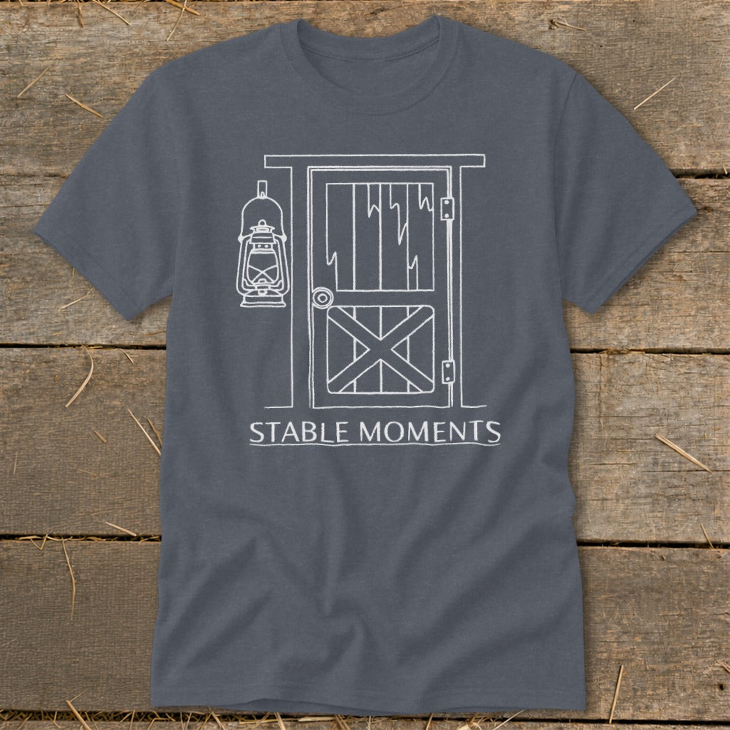 Dark grey t-shirt with white graphic of barn door, lantern, and text "STABLE MOMENTS".