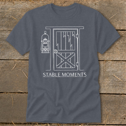 Dark grey t-shirt with white graphic of barn door, lantern, and text "STABLE MOMENTS".