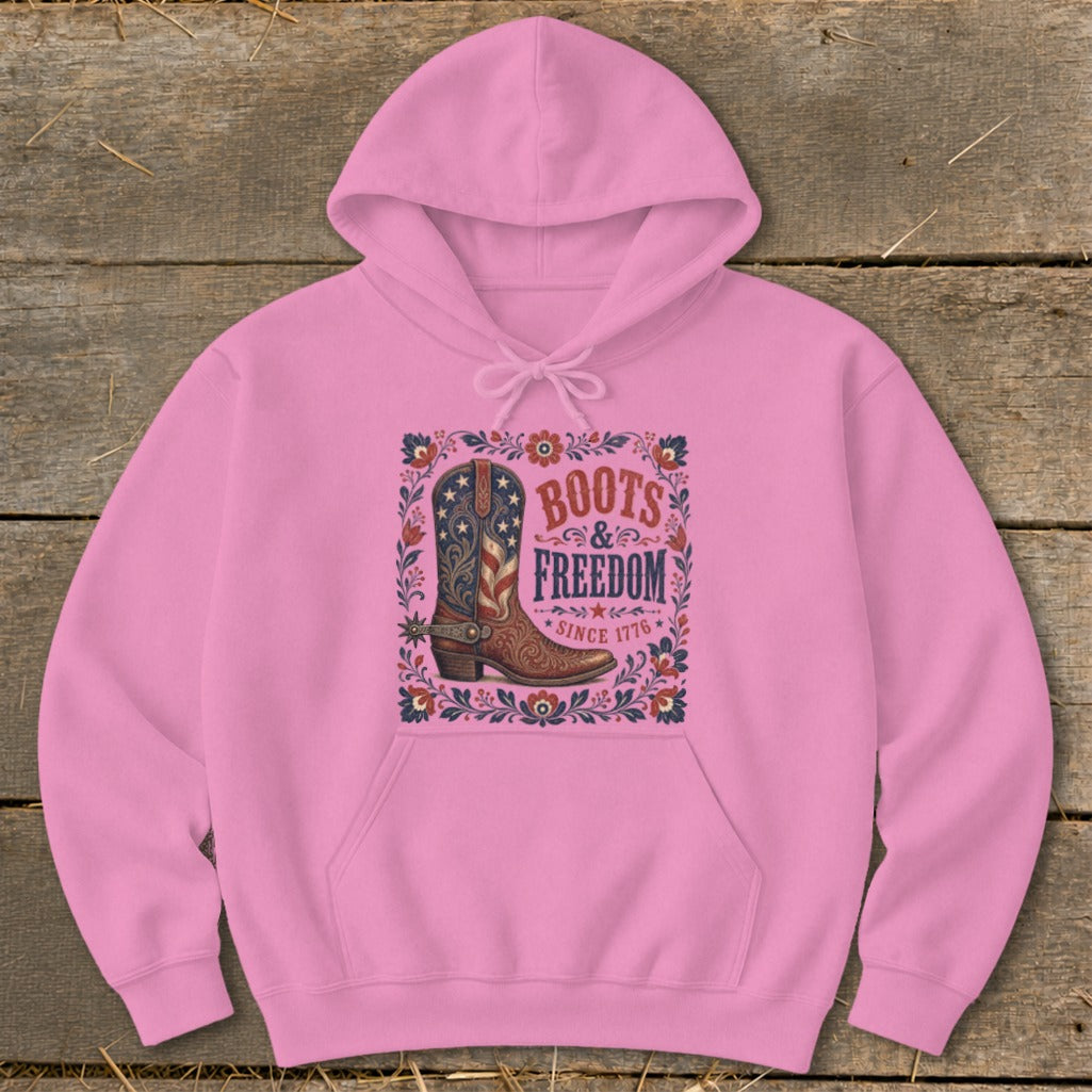 Pink hoodie with "Boots & Freedom Since 1776" graphic and cowboy boot.