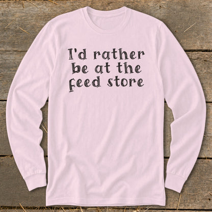 Pink long-sleeve shirt with "I'd rather be at the feed store" text.