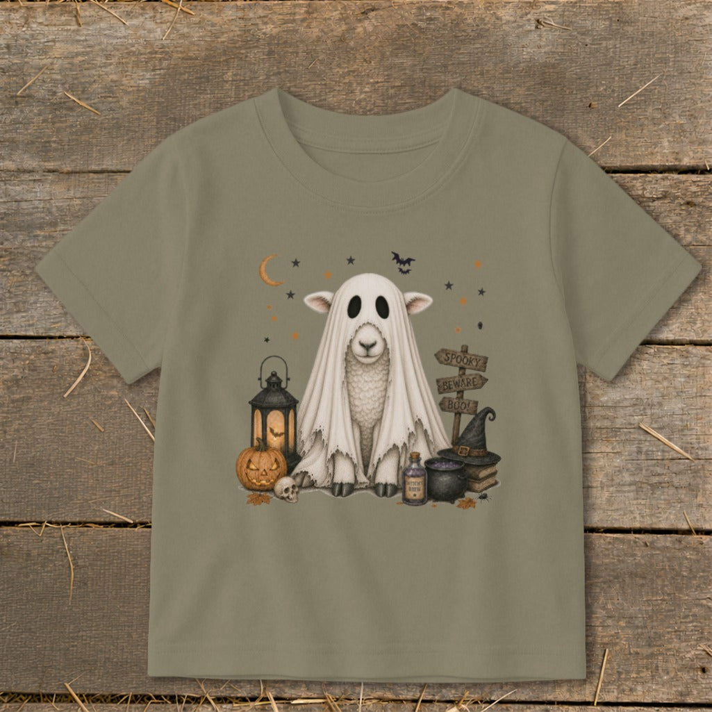 Halloween t-shirt graphic of a sheep in a ghost costume with pumpkin, lantern, and witch elements.