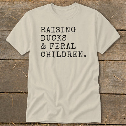 Beige t-shirt with black text "RAISING DUCKS & FERAL CHILDREN."