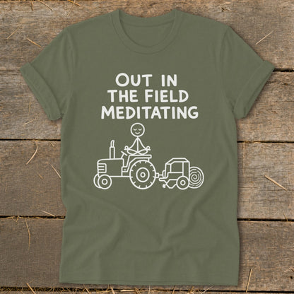 Olive green t-shirt with "Out in the Field Meditating" text and tractor graphic.
