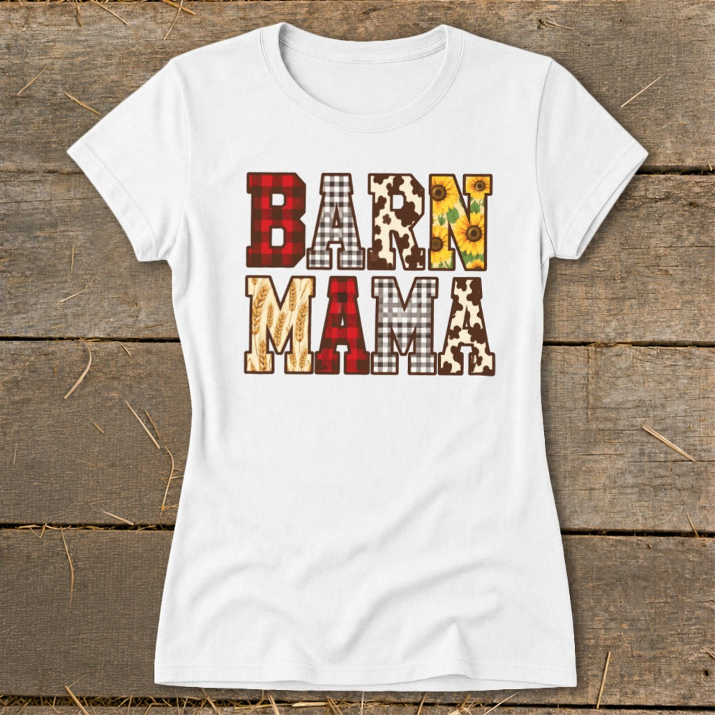 White t-shirt with "BARN MAMA" text featuring plaid, cow print, sunflowers, and wheat patterns.