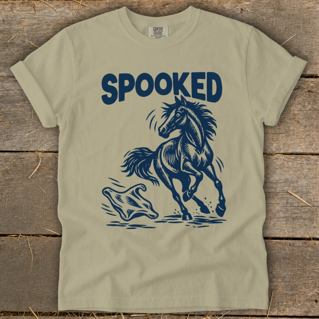 T-shirt with dark blue graphic of a startled horse running from a ghost with "SPOOKED" text.