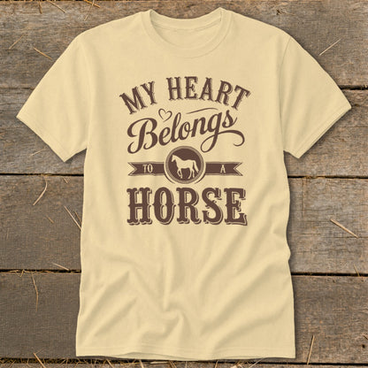 Light yellow t-shirt with brown text "My Heart Belongs To A Horse" and horse graphic.