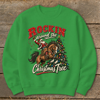 Santa riding a horse with lasso next to a Christmas tree, text "Rockin around the Christmas Tree".