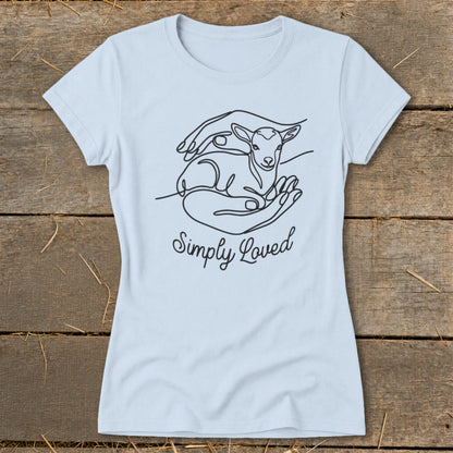 Light blue t-shirt with black line art of a lamb nestled in hands, and text "Simply Loved".