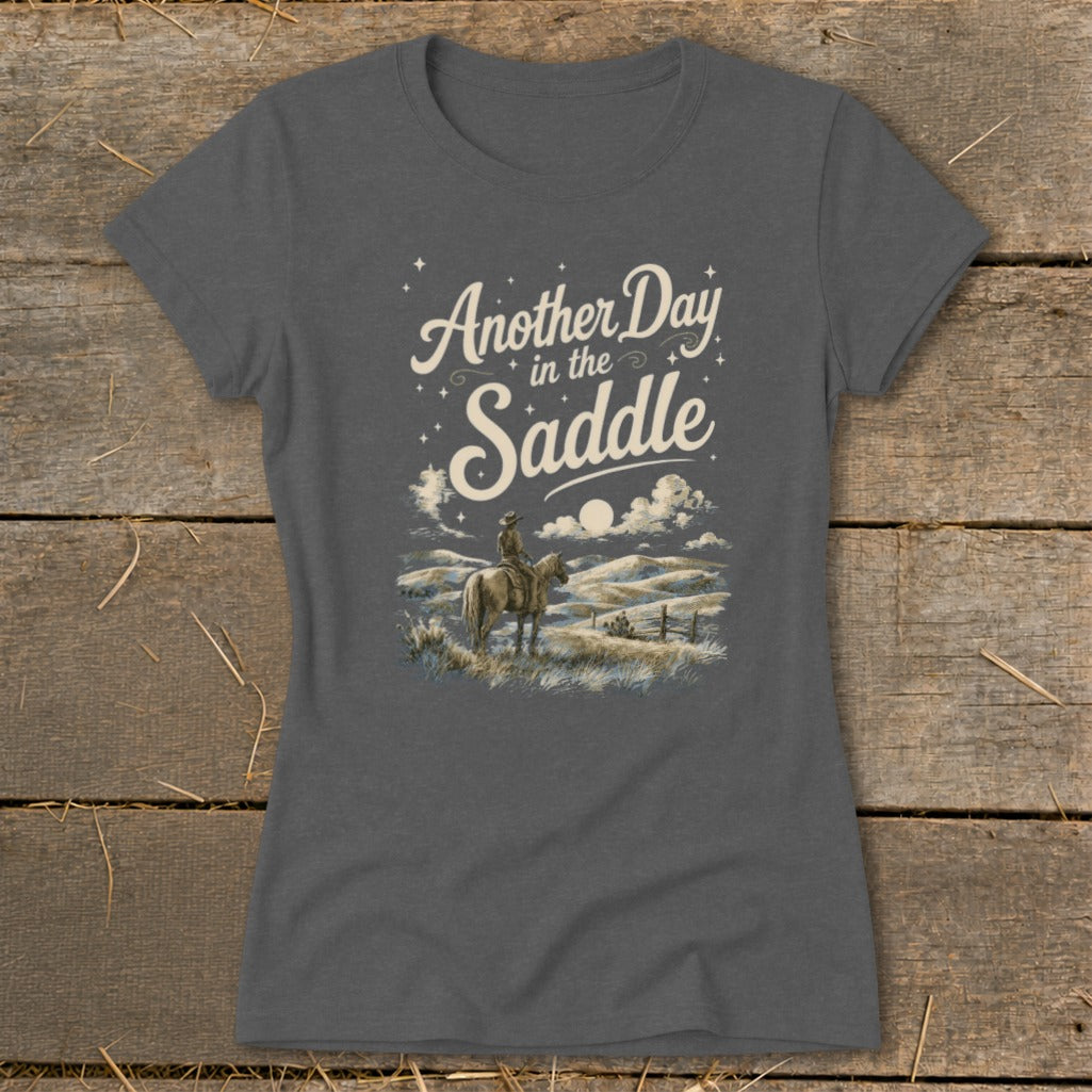 Grey t-shirt with "Another Day in the Saddle" and cowboy riding horse graphic.