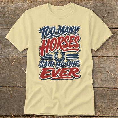 Light yellow t-shirt with "Too Many Horses Said No One Ever" text and horseshoe graphic.