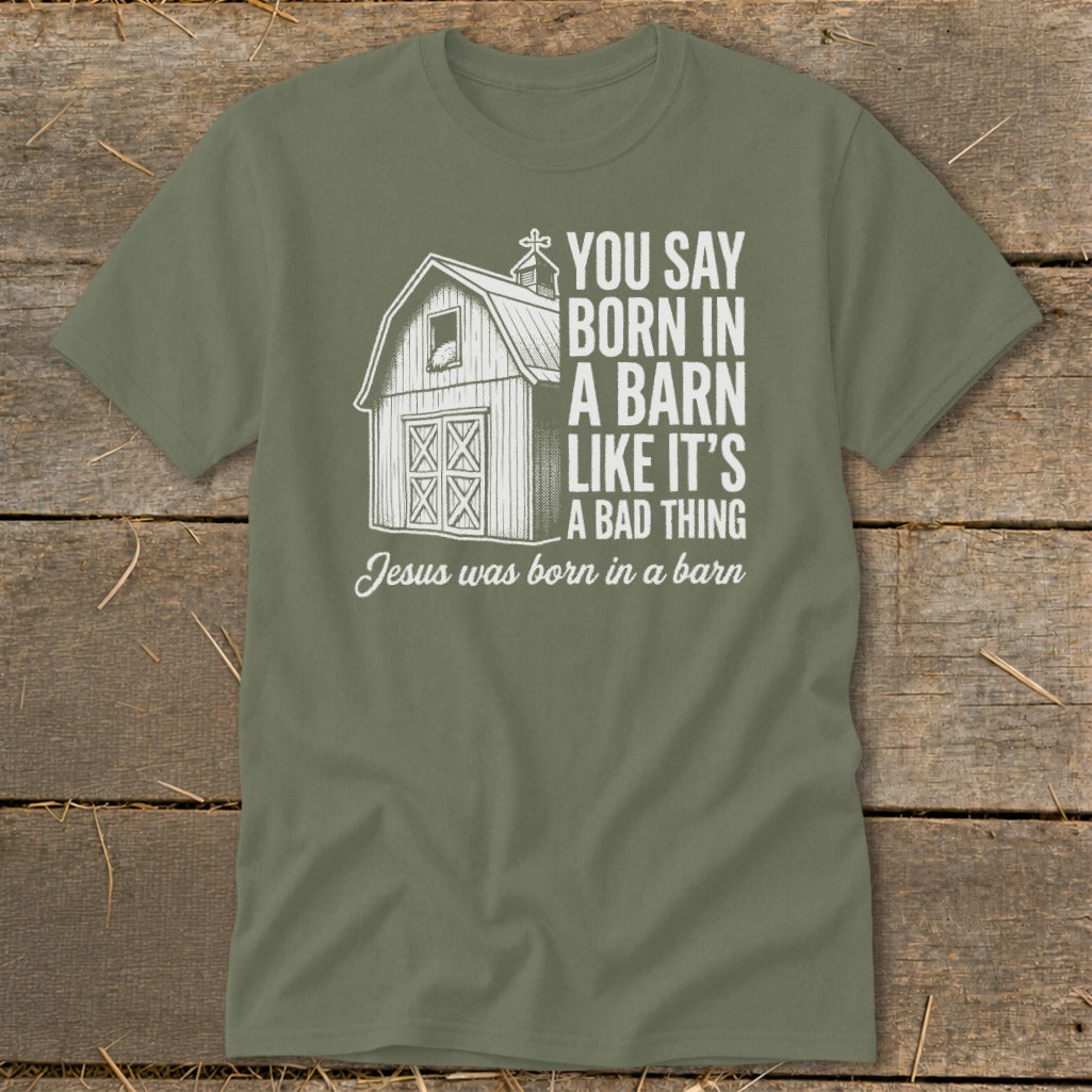 Olive green t-shirt with barn graphic and text "Jesus was born in a barn".