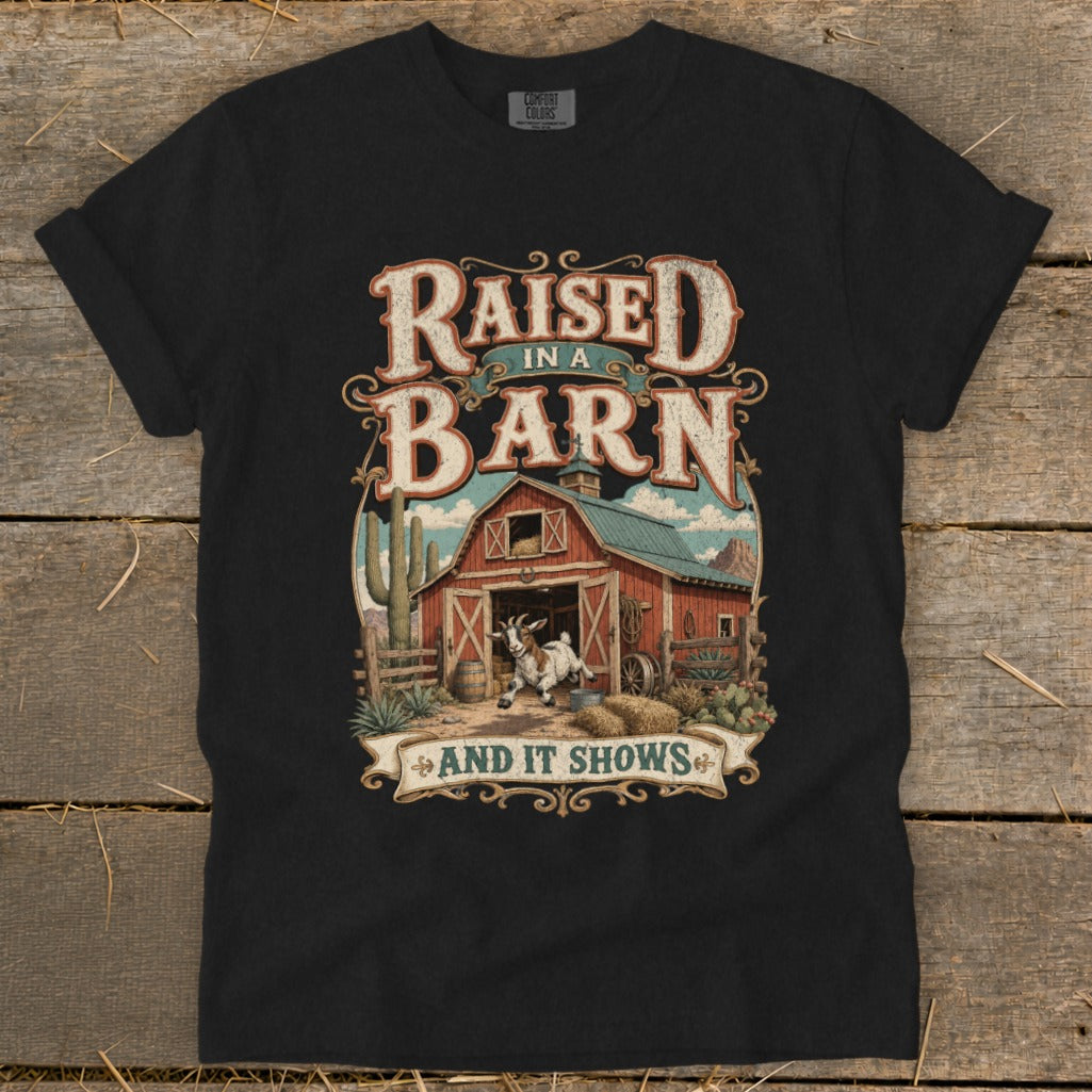 T-shirt with barn, goat, cacti, and text "Raised in a Barn and it Shows."