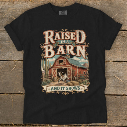 T-shirt with barn, goat, cacti, and text "Raised in a Barn and it Shows."