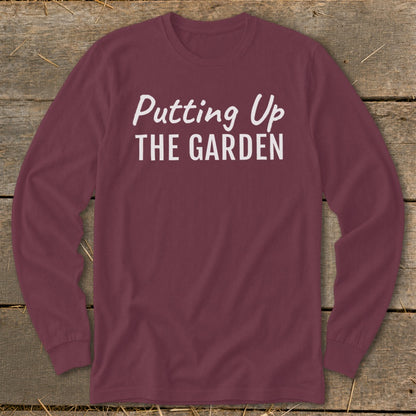 Maroon long sleeve shirt with white text "Putting Up THE GARDEN".