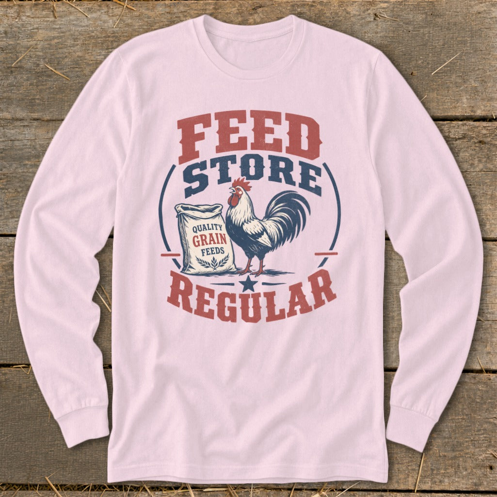 Rooster graphic with "Feed Store Regular" text and bag of grain on a pink long-sleeve shirt.