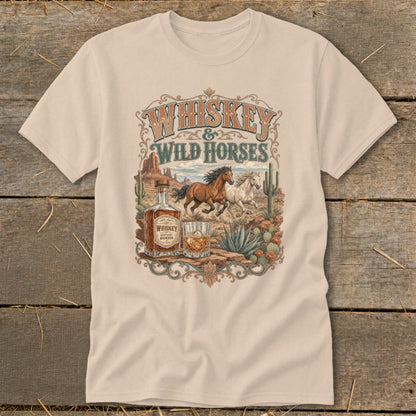 Whiskey & Wild Horses graphic tee with horses, whiskey bottle, and desert scene.
