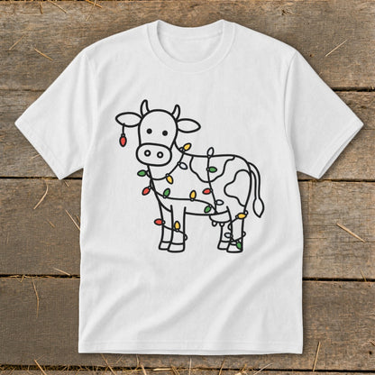 White t-shirt with a cartoon cow wrapped in colorful Christmas lights.