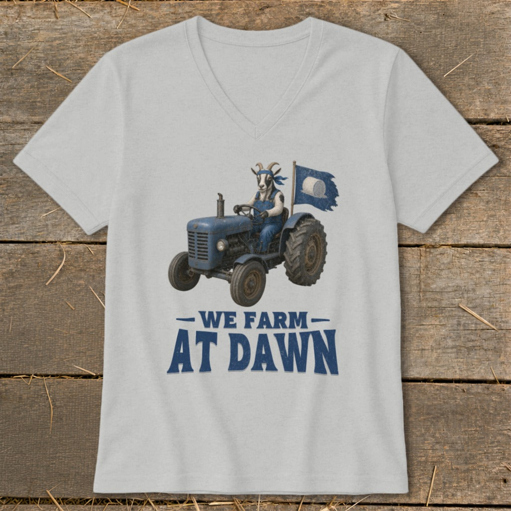 Goat in overalls driving a blue tractor with a torn blue flag, "We Farm At Dawn" text.