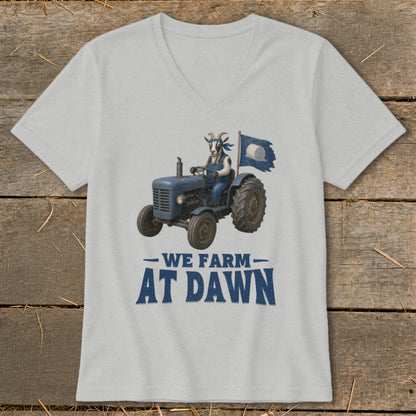 Goat in overalls driving a blue tractor with a torn blue flag, "We Farm At Dawn" text.