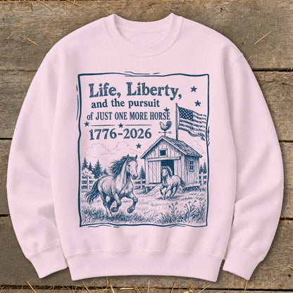 Light pink sweatshirt with a barn, horses, American flag, and text about "just one more horse."