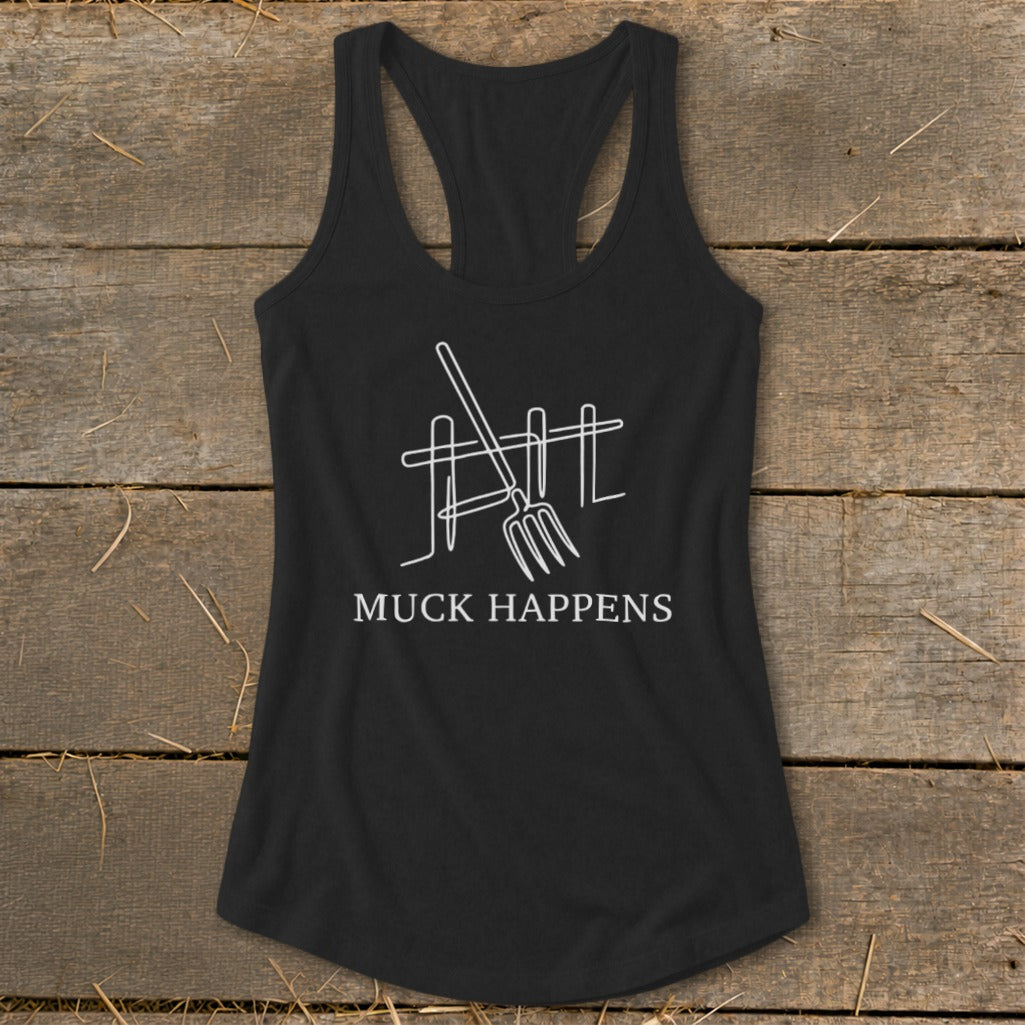 Black tank top with white graphic of pitchfork and fence, text "MUCK HAPPENS".