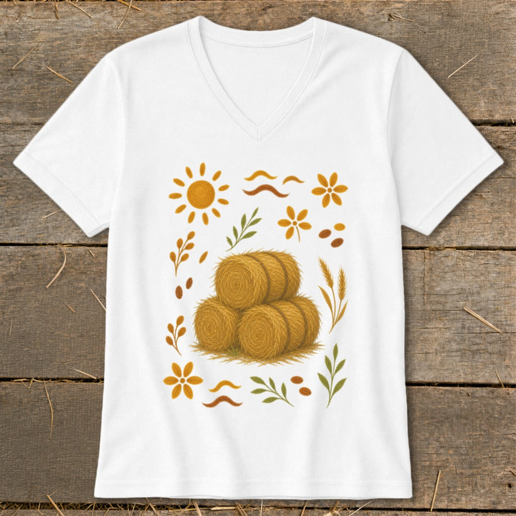 White t-shirt with a graphic of hay bales surrounded by autumn-themed elements.