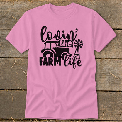 Pink t-shirt with black graphic of tractor, windmill, and text "lovin' the FARM life".