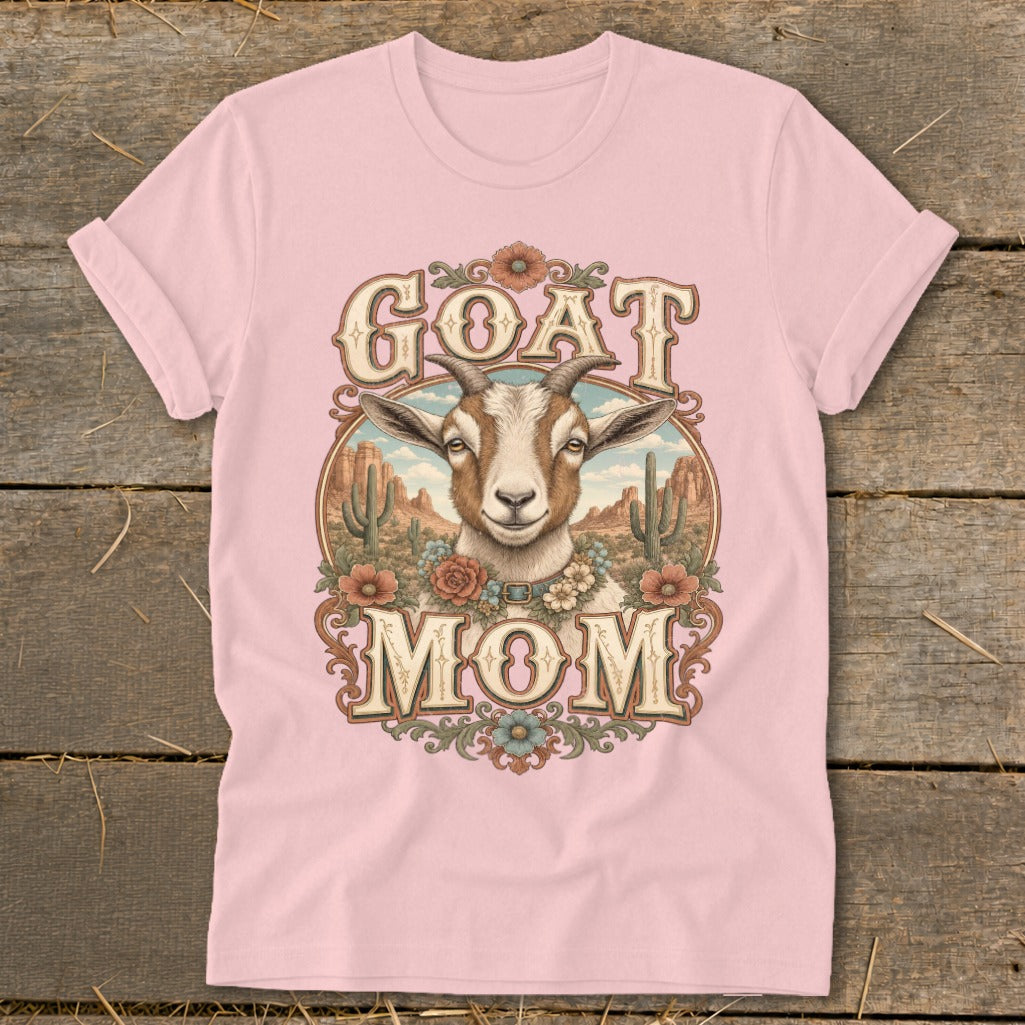 Pink t-shirt with "GOAT MOM" text and a goat illustration in a desert scene.