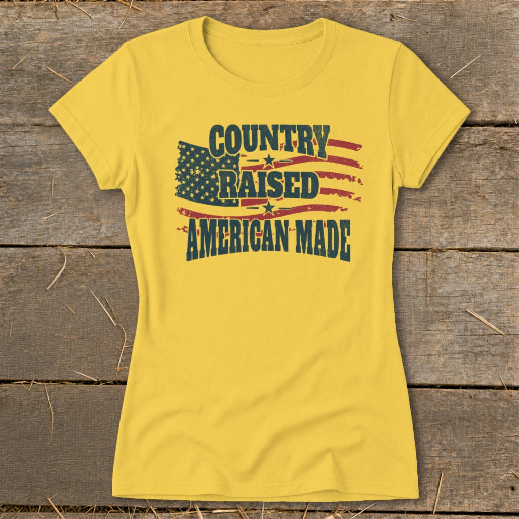 Yellow t-shirt with "Country Raised American Made" text and distressed American flag design.
