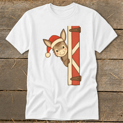 Donkey wearing Santa hat peeking from behind barn door.