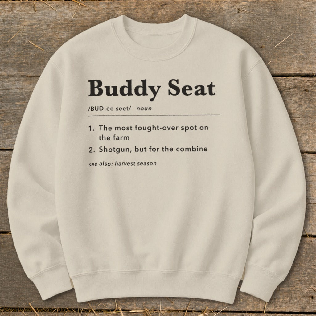 Cream sweatshirt with black text defining "Buddy Seat" and "harvest season".