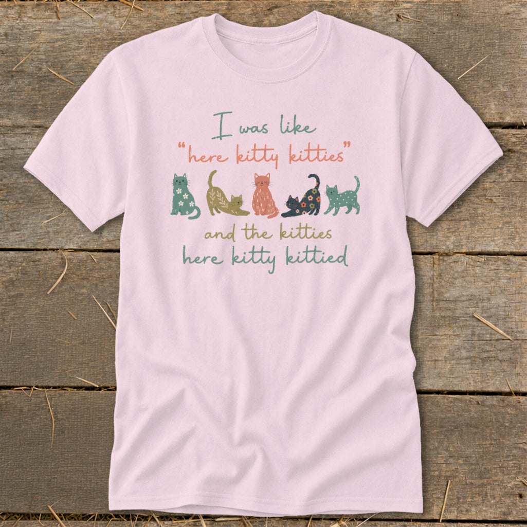 Pink t-shirt with cats and text "I was like 'here kitty kitties' and the kitties here kitty kittied".