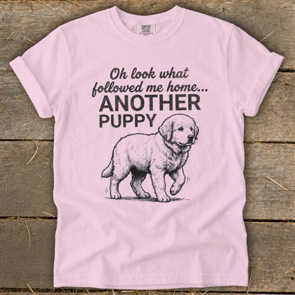 Pink t-shirt with sketch of a puppy and text "Oh look what followed me home... ANOTHER PUPPY"
