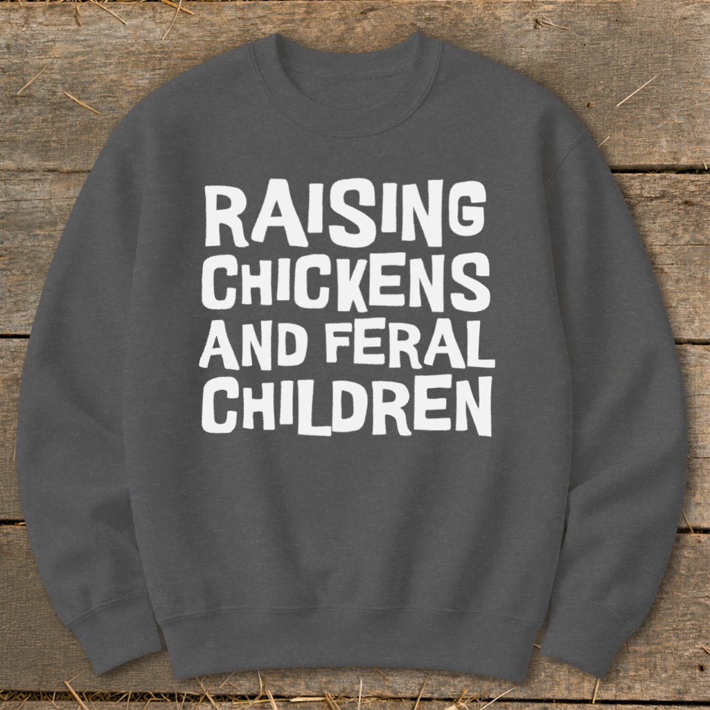 Dark gray sweatshirt with white text "Raising Chickens and Feral Children".