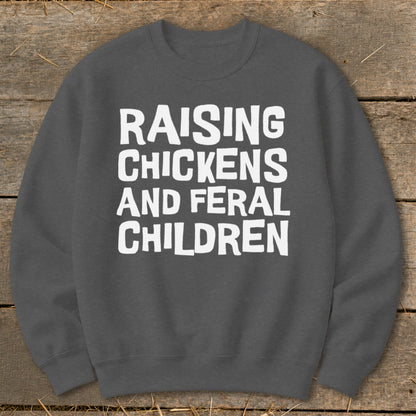 Dark gray sweatshirt with white text "Raising Chickens and Feral Children".