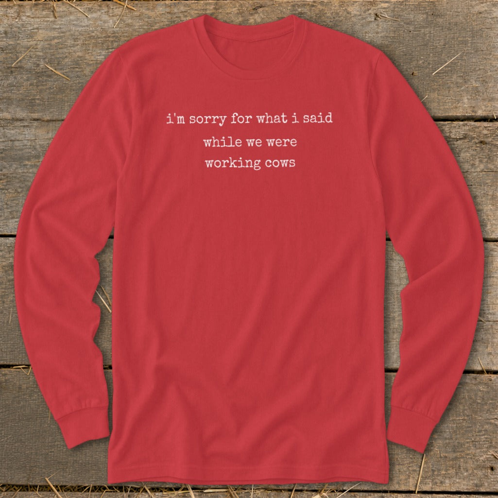 Red long-sleeve shirt with white text: "i'm sorry for what i said while we were working cows".