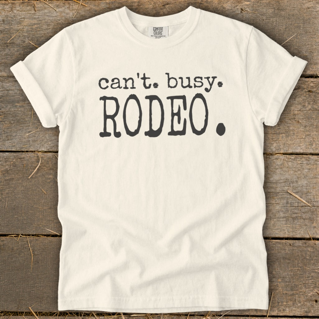 Cream t-shirt with black text that reads "can't. busy. RODEO."