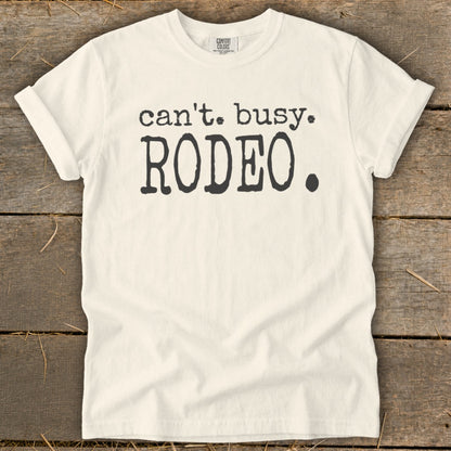 Cream t-shirt with black text that reads "can't. busy. RODEO."