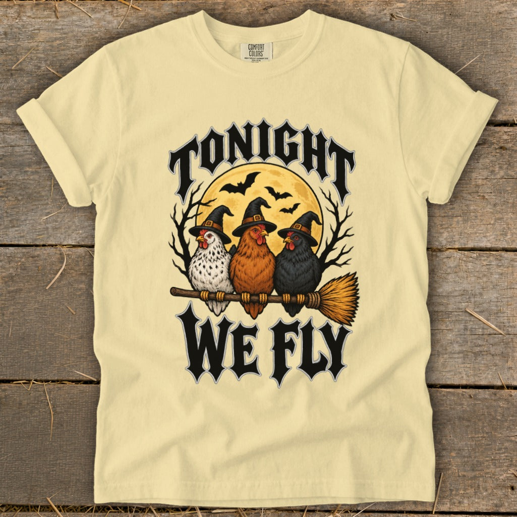 Three chickens in witch hats sit on a broom with text "TONIGHT WE FLY".