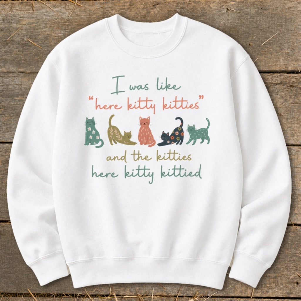 White sweatshirt with cats and text "here kitty kitties" and "here kitty kittied".