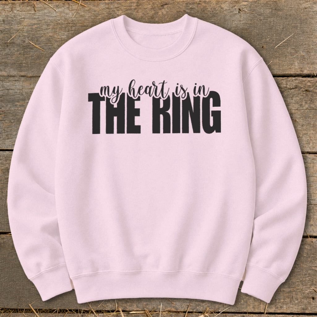 Pink sweatshirt with black text reading "my heart is in THE RING".