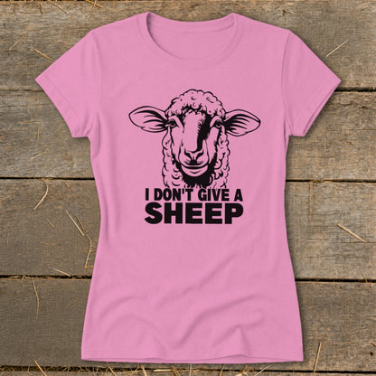Pink t-shirt with a black graphic of a sheep and the text "I DON'T GIVE A SHEEP".