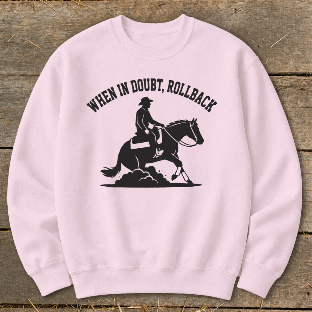 Light pink sweatshirt with black graphic of horse and rider saying "When in doubt, rollback".