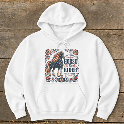 White hoodie with patriotic horse and rider graphic, "250 Years of Horse & Rider 1776-2026" text.