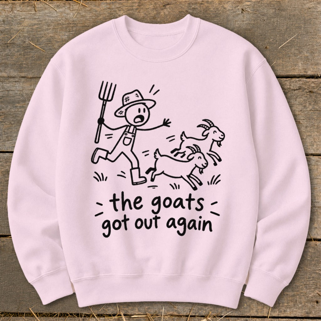 Pink sweatshirt with a drawing of a farmer chasing goats, text "the goats got out again".