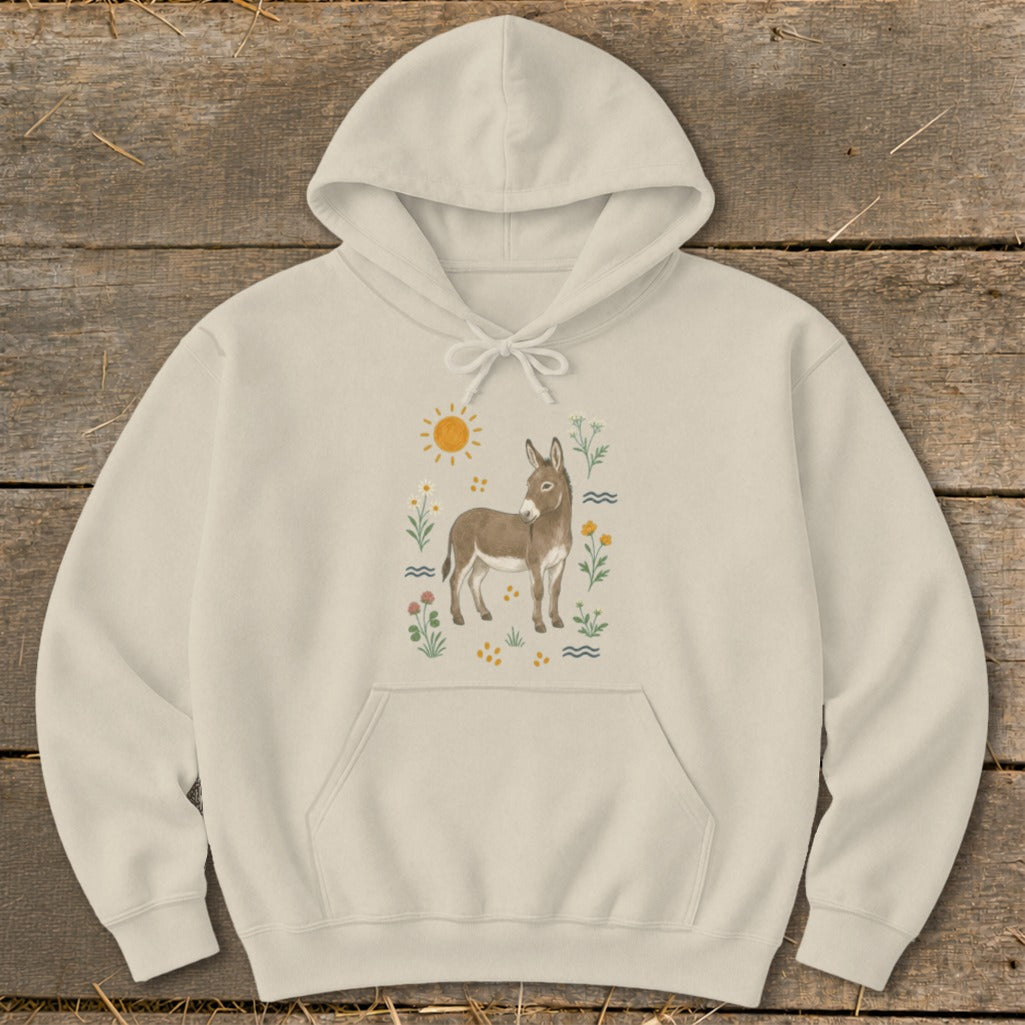 Cream hoodie with a watercolor-style illustration of a donkey surrounded by flowers and a sun.