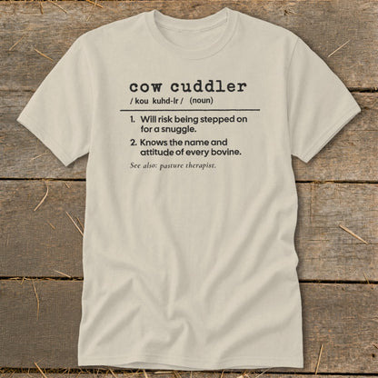 Light beige t-shirt with "cow cuddler" definition printed on it.