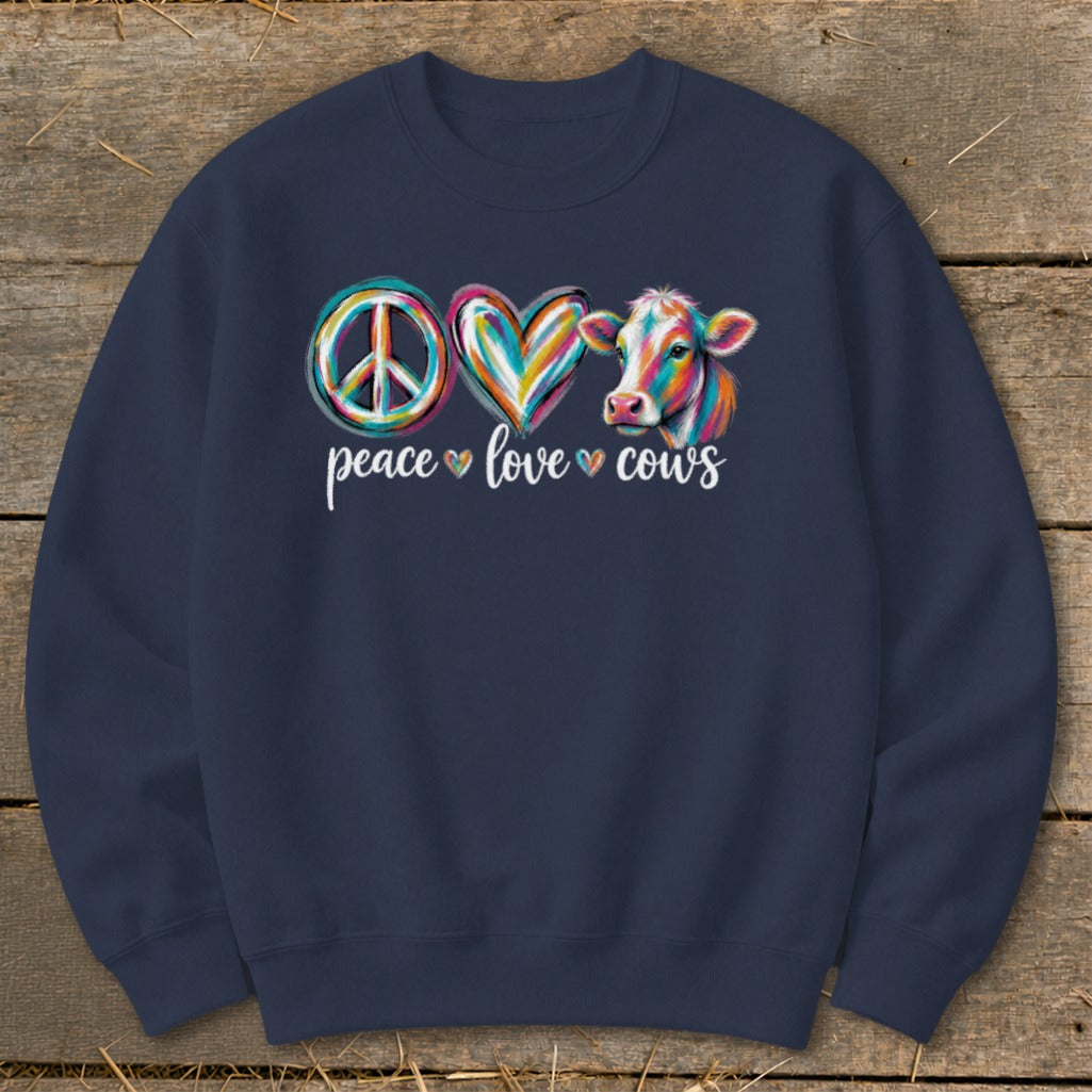 Peace, love, cows graphic with colorful peace sign, heart, and cow on dark blue sweatshirt.